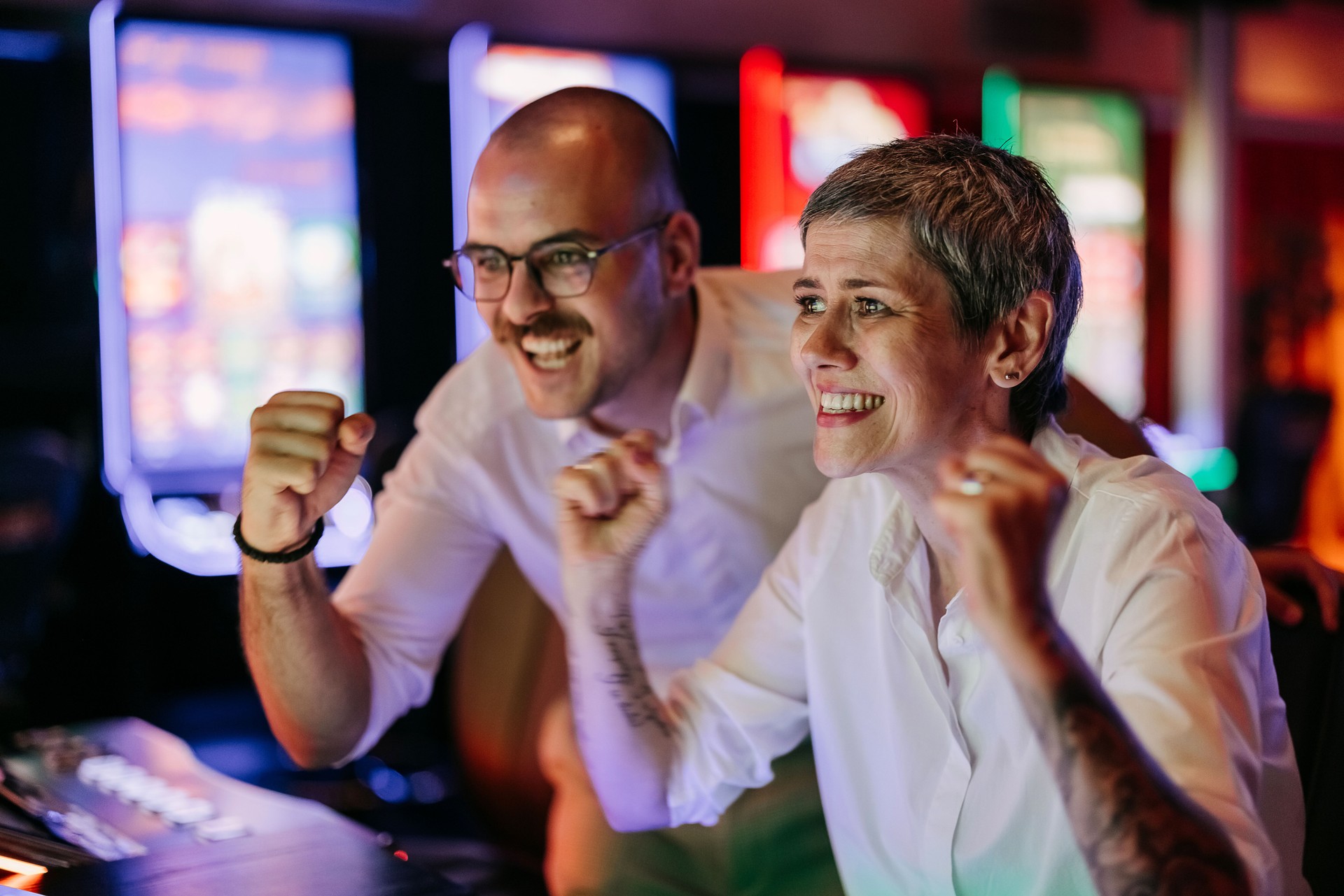 Two friends gambling on slot machine